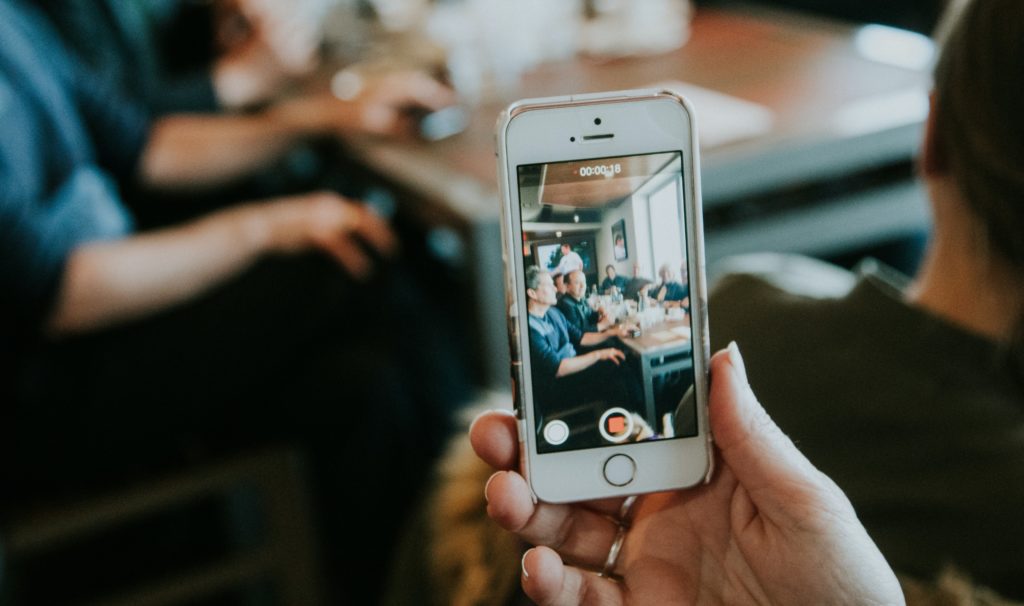 A person filming video content with their phone