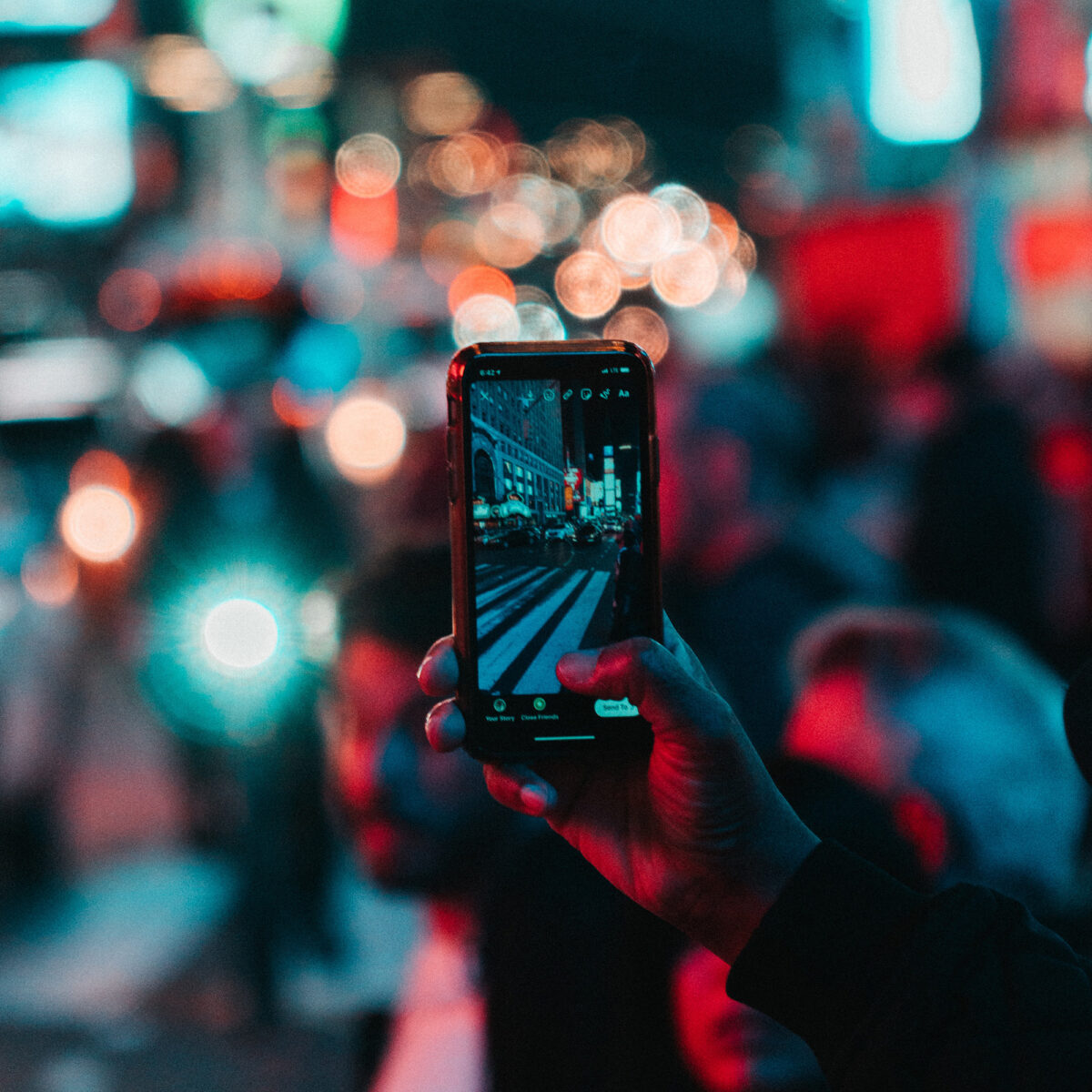 A photo of Times Square, New York, being taken on a phone
