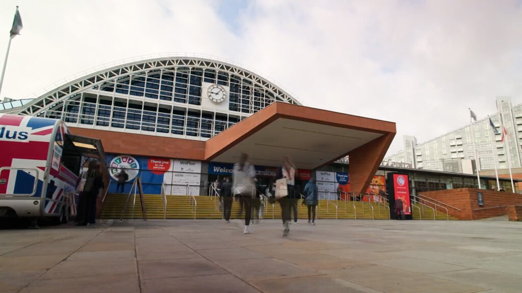 Screengrab of a timelapse video showing people arriving at the front entrance of Manchester Central Convention Complex