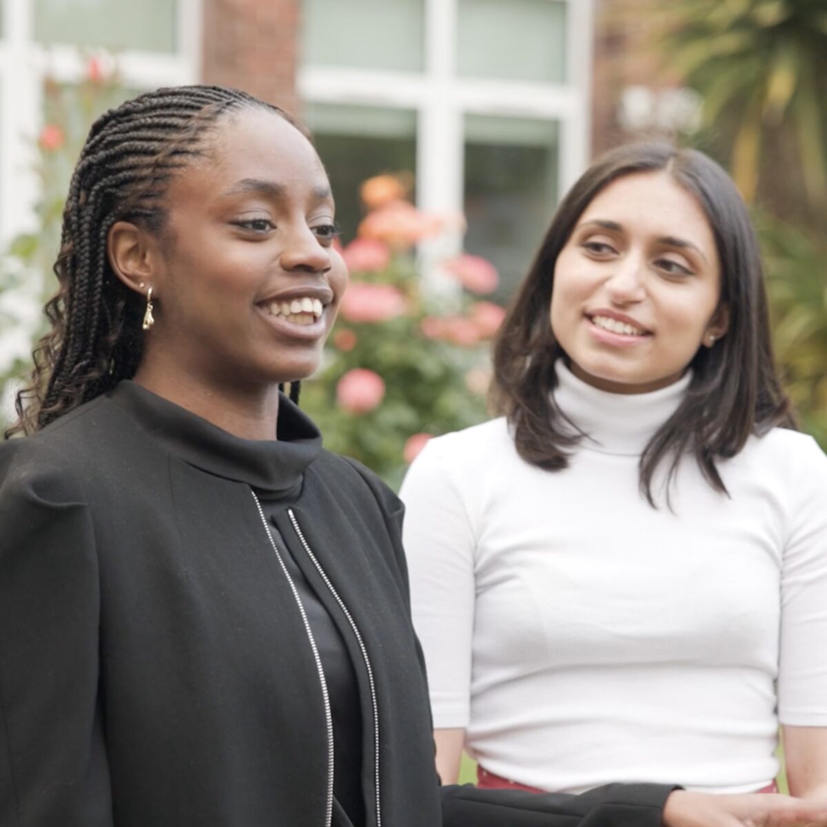 Screenshot from Manchester High School for Girls charity fundraising film, showing two alumnae smiling and chatting.