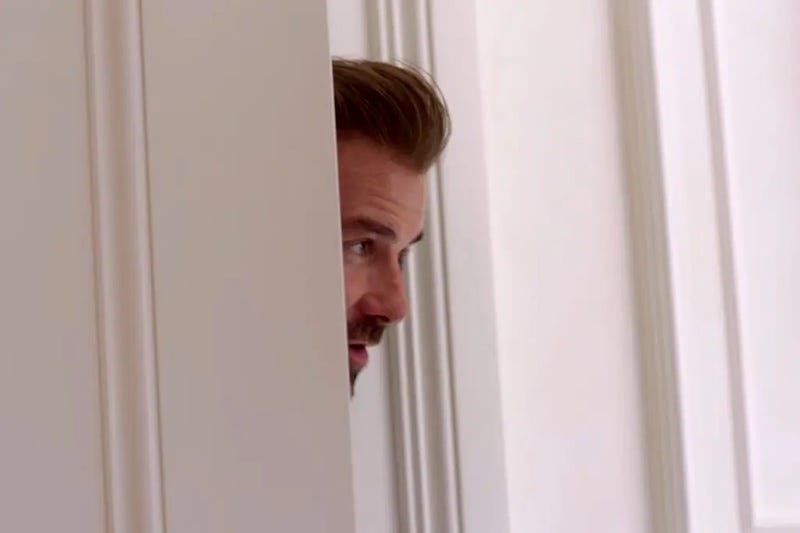 David Beckham peeking his head through a door, saying "be honest".